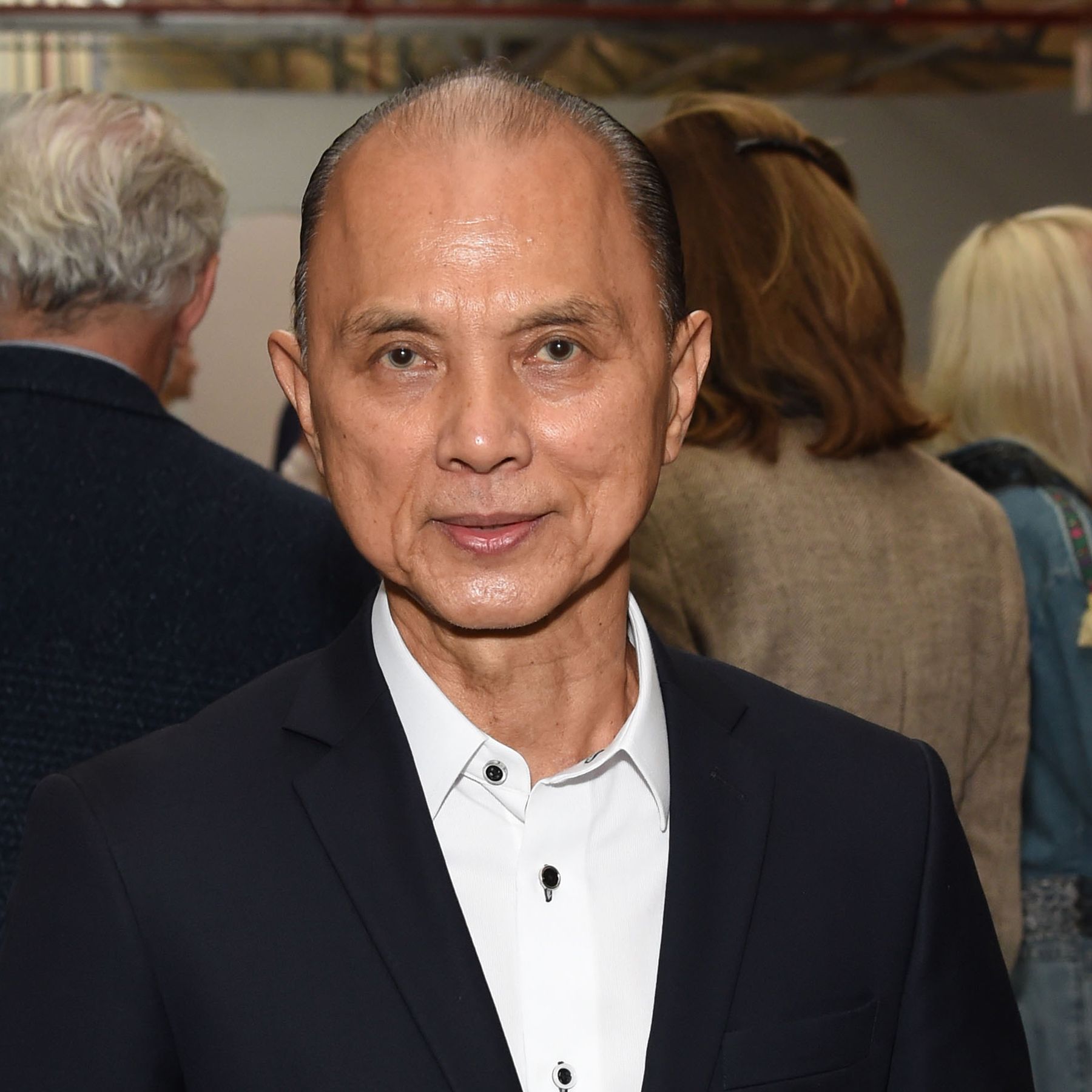 Jimmy Choo person biography: From humble beginnings to a fashion empire.